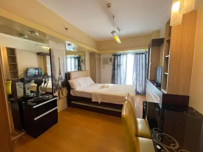 a small room with a bed and a television at 8 Adriatico Staycation in Manila
