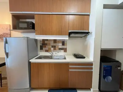 a small kitchen with a sink and a refrigerator at 8 Adriatico Staycation in Manila