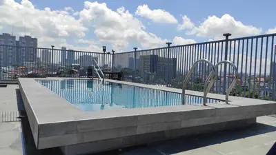 a swimming pool on the roof of a building at Nest Fort BGC in Manila