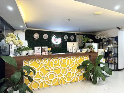 a restaurant with a yellow and white counter with plants at Nest Fort BGC in Manila