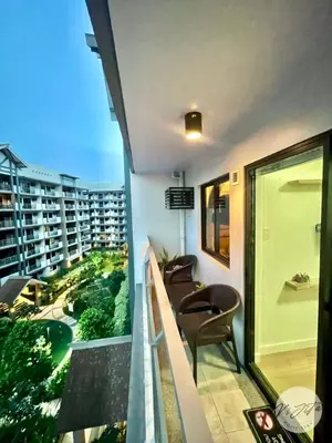 a balcony with chairs and a view of a city at Homestay by ViJiTa 2bedroom condo in Manila