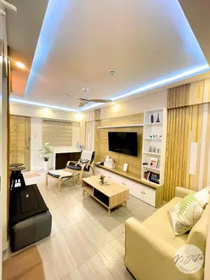 a living room with a couch and a tv at Homestay by ViJiTa 2bedroom condo in Manila