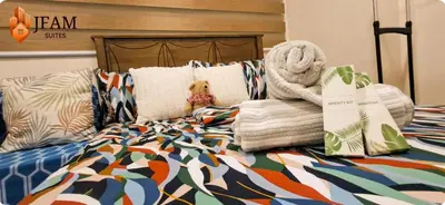 a bed with a comforter and towels on it at JFam Suites, C3-3N Studio, Up To 4 Pax in Biñan