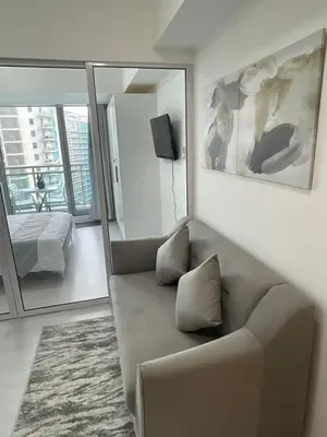 a living room with a couch and a mirror at Azure Urban Resort Residences in Manila