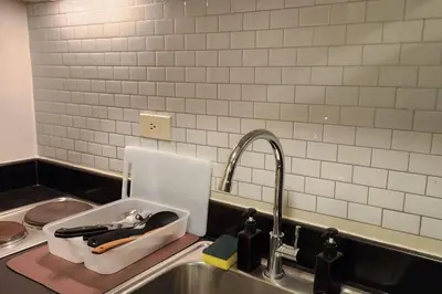 a kitchen counter with a sink and a sink at Chill Apartment in Makati in Manila