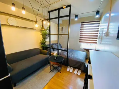a living room with a couch and a table at Brand New Studio in Pasig with Free Pool Access in Manila