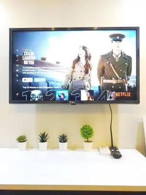 a flat screen tv hanging on a wall at Brand New Studio in Pasig with Free Pool Access in Manila