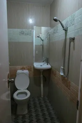a bathroom with a toilet and a sink at Villa Elsie Resort and Hotel in General Trias