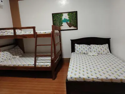 a room with two bunk beds and a bed at Villa Elsie Resort and Hotel in General Trias