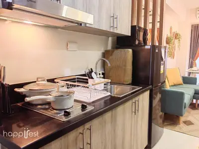 a kitchen with a stove with pots and pans on it at Happirest at S Residences w/Balcony, Mall of Asia in Manila