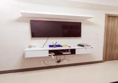 a living room with a tv on a white wall at S Residences1 bedroom with balcony near MOA in Manila