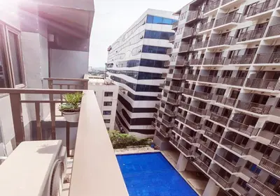 a balcony of a building with a swimming pool at S Residences1 bedroom with balcony near MOA in Manila