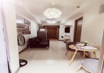 a living room with a couch and a table at S Residences1 bedroom with balcony near MOA in Manila