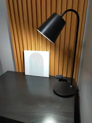 a black lamp sitting on top of a table at Stylish 2BR w/ Free Pool Access and Parking LG03 in Manila