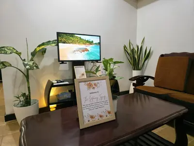 a living room with a coffee table and a tv at Acacia Estates' The Getaway Taguig Jade Tower in Manila