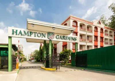 a building with a sign that reads hampton gardens at Cozy 2BR w/ Free Pool Access and Free Parking N224 in Manila