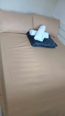 a bed with two pillows on top of it at MOA Staycation - Ashti in Manila