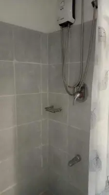 a bathroom with a shower with a shower curtain at MOA Staycation - Ashti in Manila