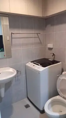 a bathroom with a toilet and a sink at MOA Staycation - Ashti in Manila