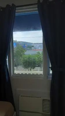 a window with a view of a building at MOA Staycation - Ashti in Manila
