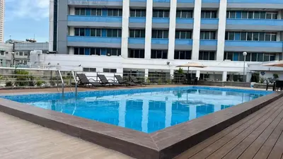 a large swimming pool in front of a building at Pearl Manila Hotel in Manila