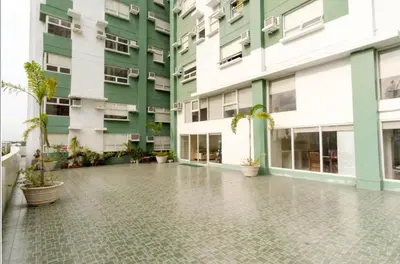 an empty courtyard of a building with potted plants at Homes by Gilmore Tower Suites in Manila