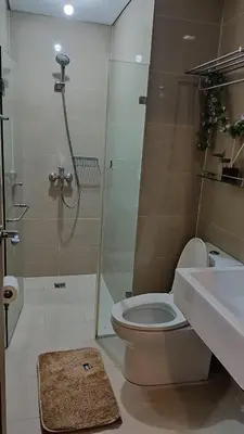 a bathroom with a shower and a toilet and a sink at Condotel in front of Terminal 3 in Manila