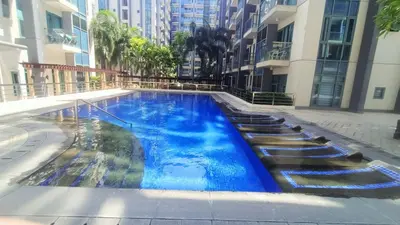 a swimming pool in the middle of a building at Condotel in front of Terminal 3 in Manila