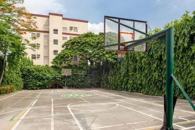 a basketball hoop on a court in front of a building at Spacious 2BR w/ Free Pool Access and Parking (709) in Manila