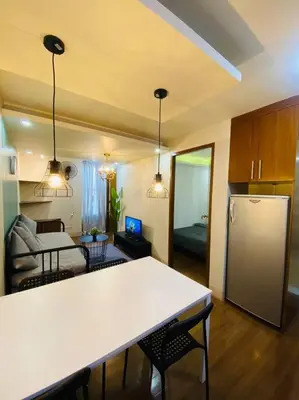 a room with a kitchen and a living room with a refrigerator at Spacious 2BR w/ Free Pool Access and Parking (709) in Manila