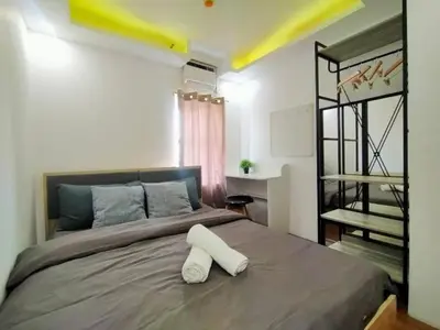 a bedroom with a large bed with two white pillows on it at Spacious 2BR w/ Free Pool Access and Parking (709) in Manila