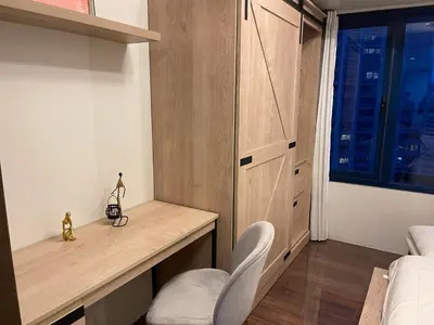 a bedroom with a desk and a bed and a window at Destina Stays, Cozy & Netflix @Air Residences, Makati, Metro Manila in Manila