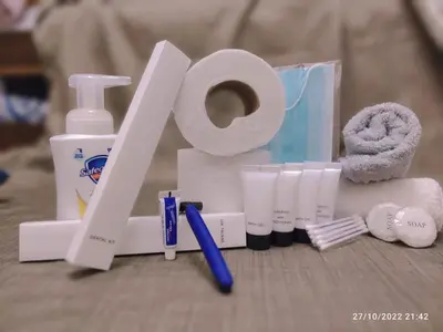 a pile of toiletries and a roll of toilet paper at Destina Stays, Cozy & Netflix @Air Residences, Makati, Metro Manila in Manila