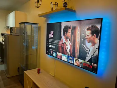 a large flat screen tv hanging on a wall at Destina Stays, Cozy & Netflix @Air Residences, Makati, Metro Manila in Manila