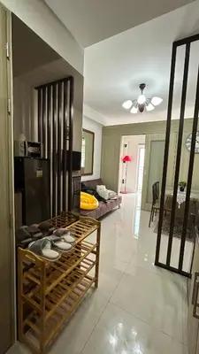a living room with a table and a couch at Shore Residences in Manila