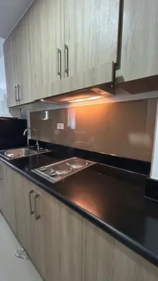 a kitchen with a sink and a counter top at Shore Residences in Manila