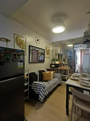 a living room with a couch and a table at PARANAQUE STAYCATION at SPRING RESIDENCES T3 U1231 in Manila