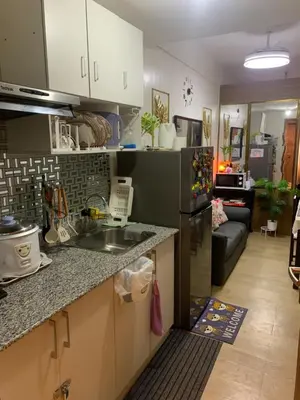 a kitchen with a sink and a refrigerator at PARANAQUE STAYCATION at SPRING RESIDENCES T3 U1231 in Manila
