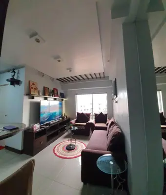 a living room with a couch and a television at Near Manila Airport, MAILZ HOMEZ COZY 2 Bedroom Condo, Full Kitchen, Swimming Pool, WIFI, 4R in Manila
