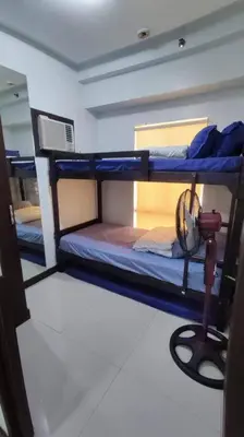 a room with three bunk beds in a boat at Near Manila Airport, MAILZ HOMEZ COZY 2 Bedroom Condo, Full Kitchen, Swimming Pool, WIFI, 4R in Manila
