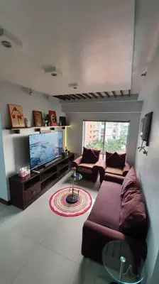 a living room with two couches and a flat screen tv at Near Manila Airport, MAILZ HOMEZ COZY 2 Bedroom Condo, Full Kitchen, Swimming Pool, WIFI, 4R in Manila