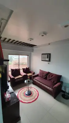 a living room with two couches and a table at Near Manila Airport, MAILZ HOMEZ COZY 2 Bedroom Condo, Full Kitchen, Swimming Pool, WIFI, 4R in Manila