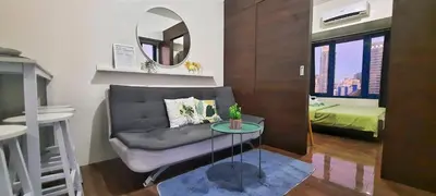 a living room with a couch and a mirror at Air Residences -City View in Manila
