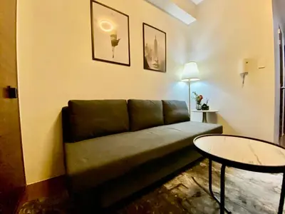 a living room with a couch and a table at Air Residences -City View in Manila