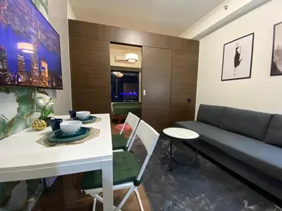 a living room with a table and a couch at Air Residences -City View in Manila