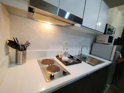 a kitchen with a sink and a counter top at Air Residences -City View in Manila