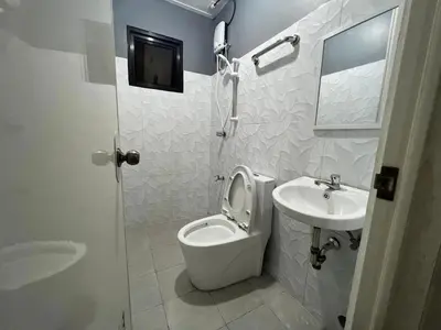 a white bathroom with a toilet and a sink at P3K Suites Budget Hotel in Manila