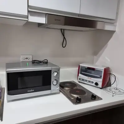 a kitchen counter with a microwave and a toaster oven at UNIT 4765 AIR in Manila