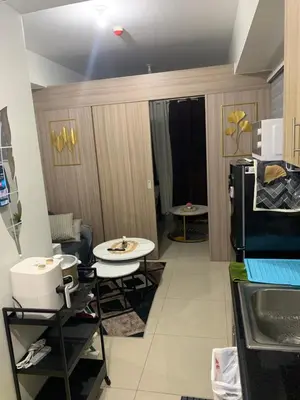 a small room with a kitchen with a refrigerator at SHORE 2 MOA Staycation T2 U1712 in Manila
