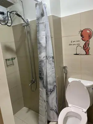 a bathroom with a shower with a toilet and a shower curtain at SHORE 2 MOA Staycation T2 U1712 in Manila